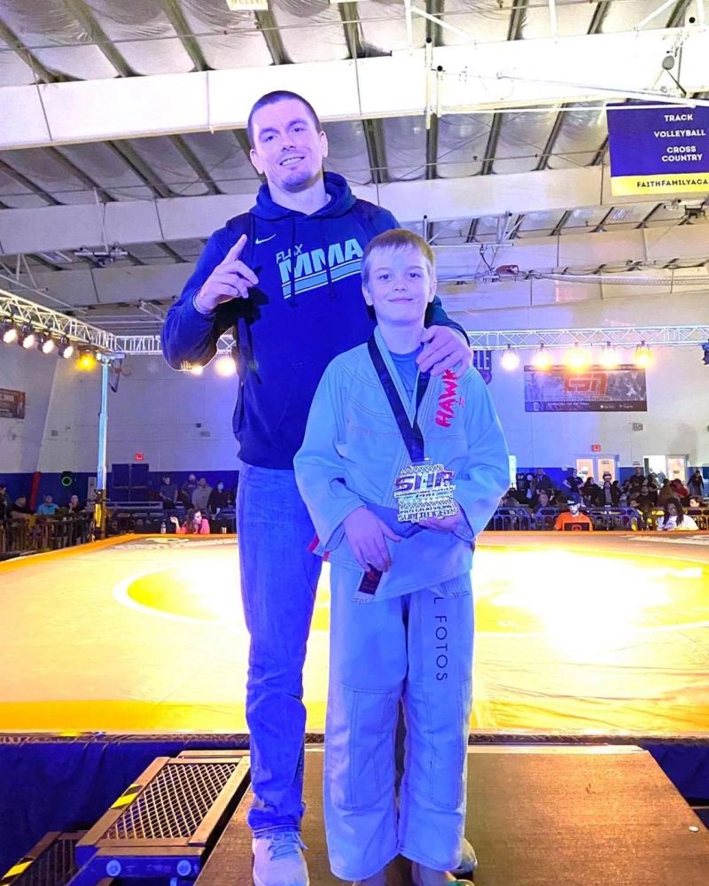 Kyle Short with a young athlete at a jiu-jitsu tournament